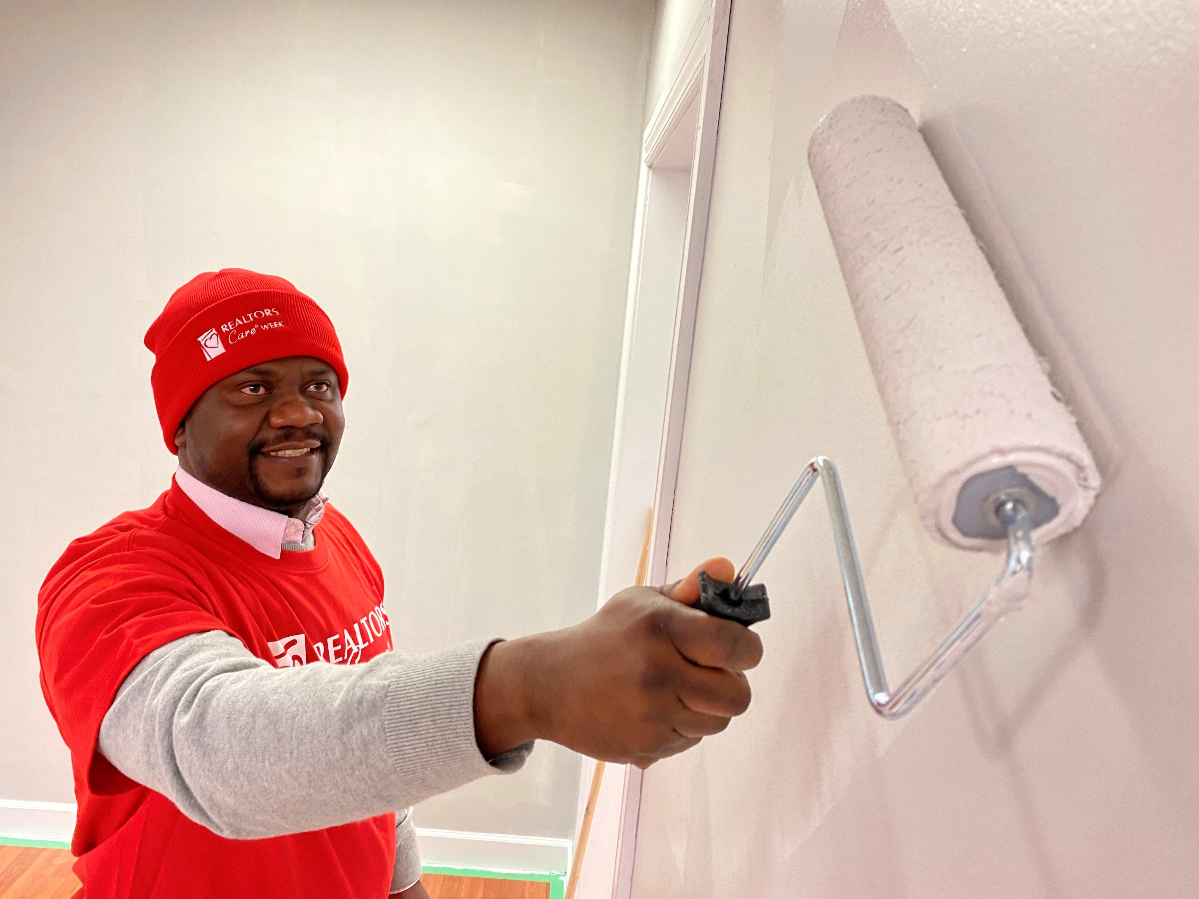 REALTOR painting wall in newcomer centre