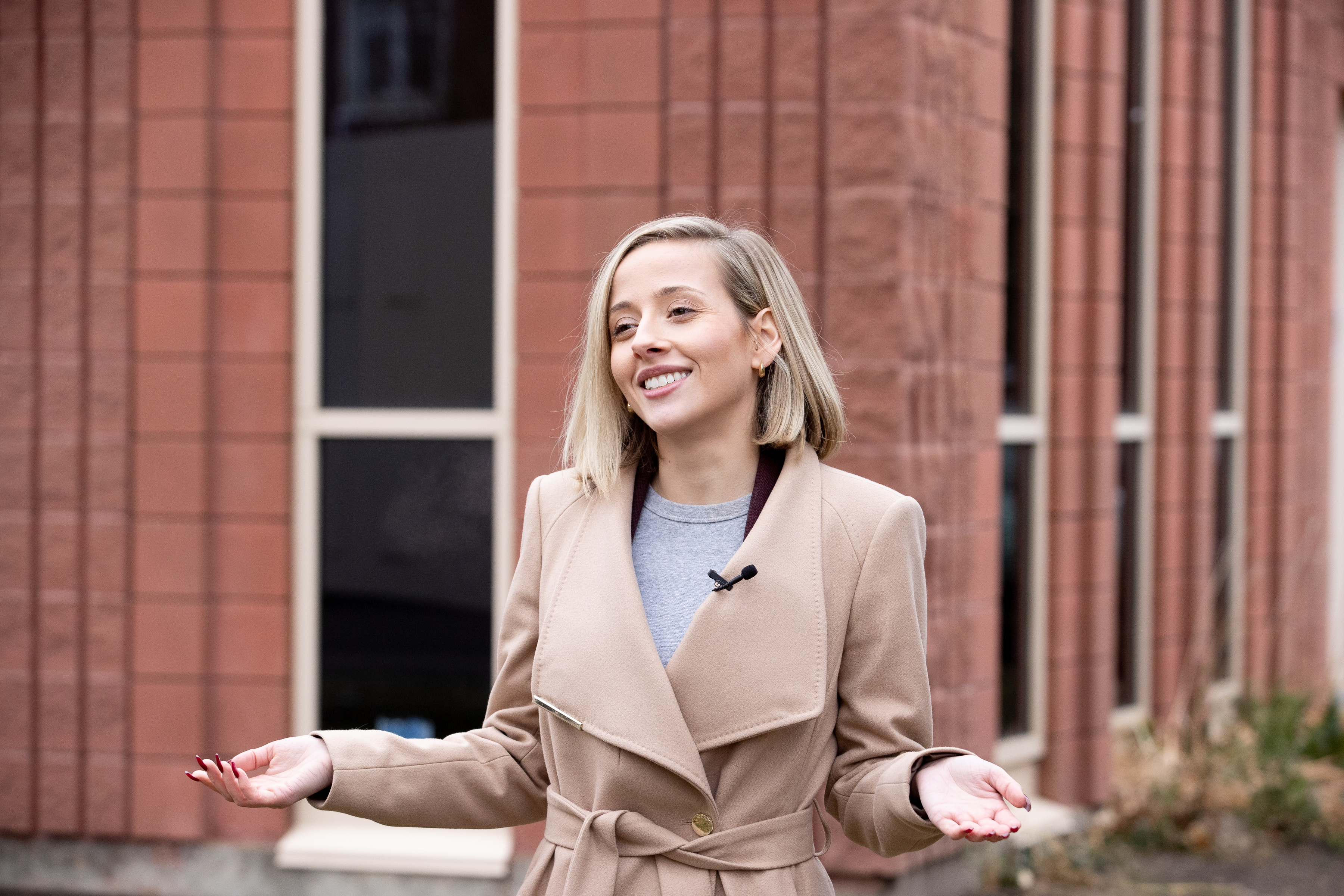 Woman standing in front of building. 