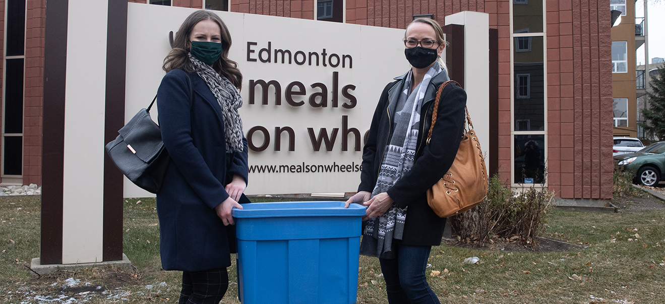 Two women hold food.