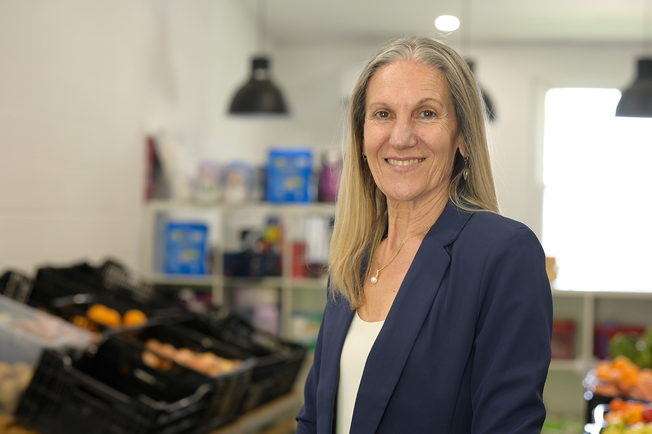 Rose Iannacchino stands in the middle of the Grow Food market smiling