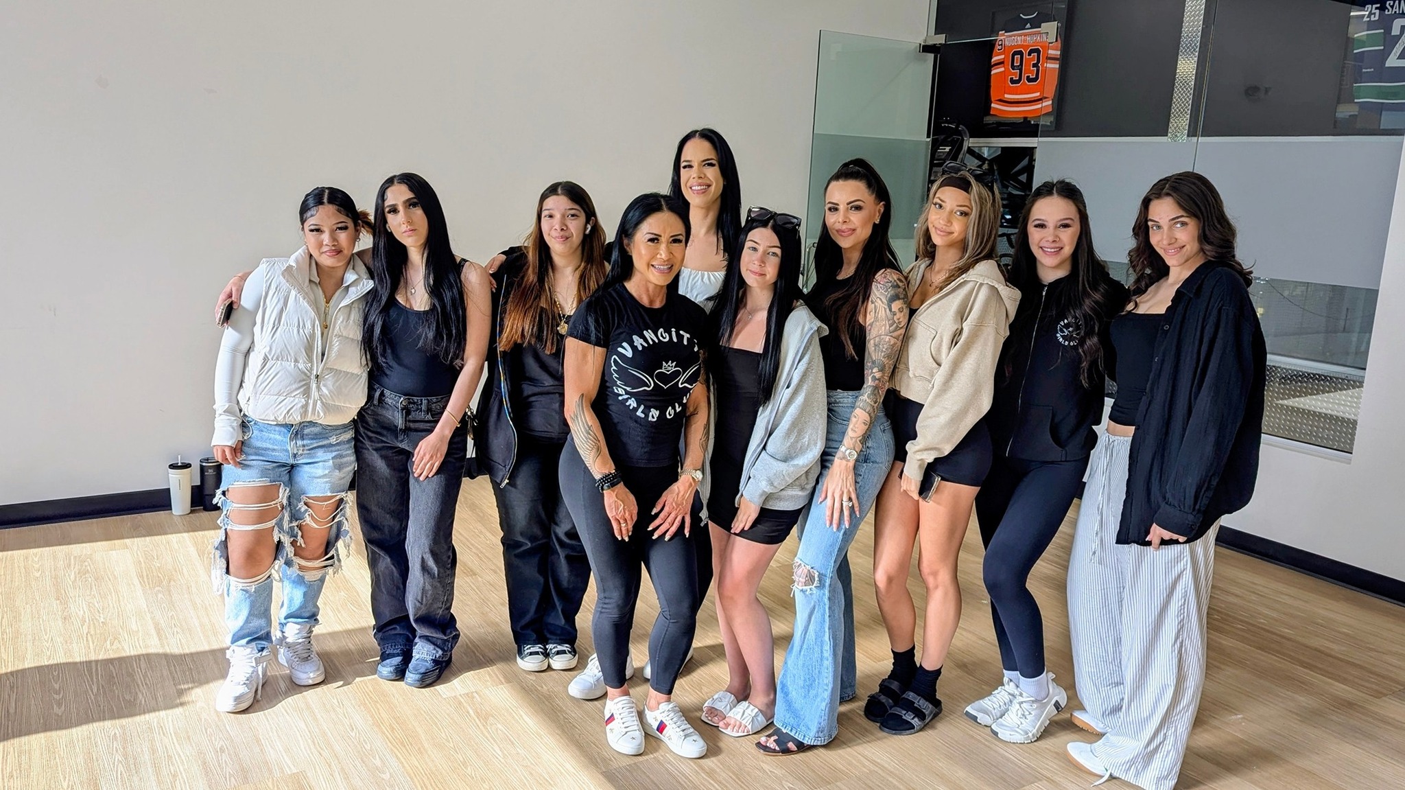 Vancity Girls Club members and mentors smile after a weekly meeting -- Les membres et mentors du Vancity Girls Club sourient après une réunion hebdomadaire