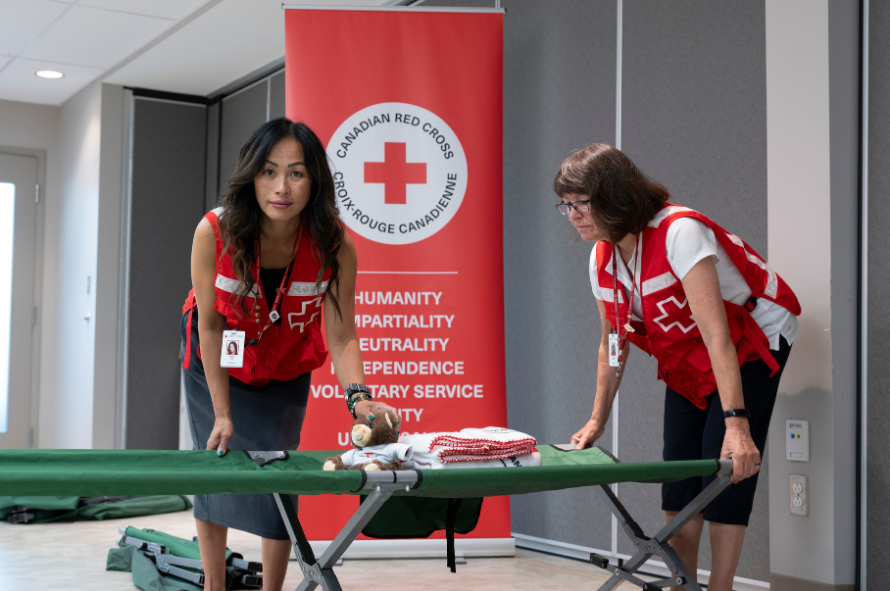Sandi sets up an Emergency Shelter cot and supplies for the Red Cross